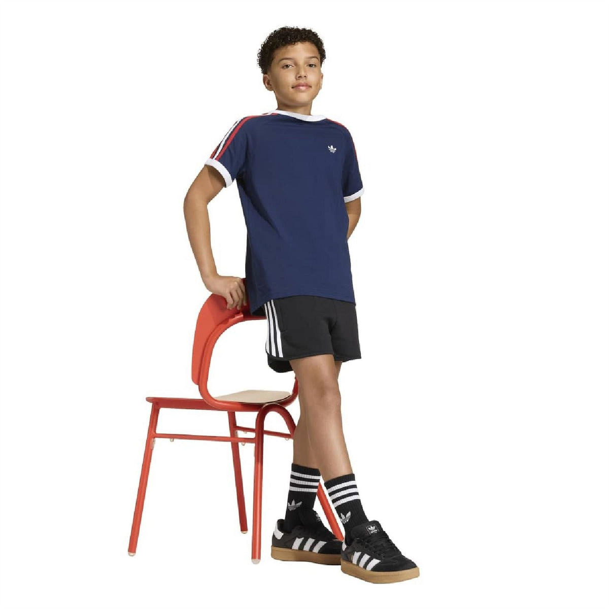 Black athletic shorts for juniors with three white stripes along the side