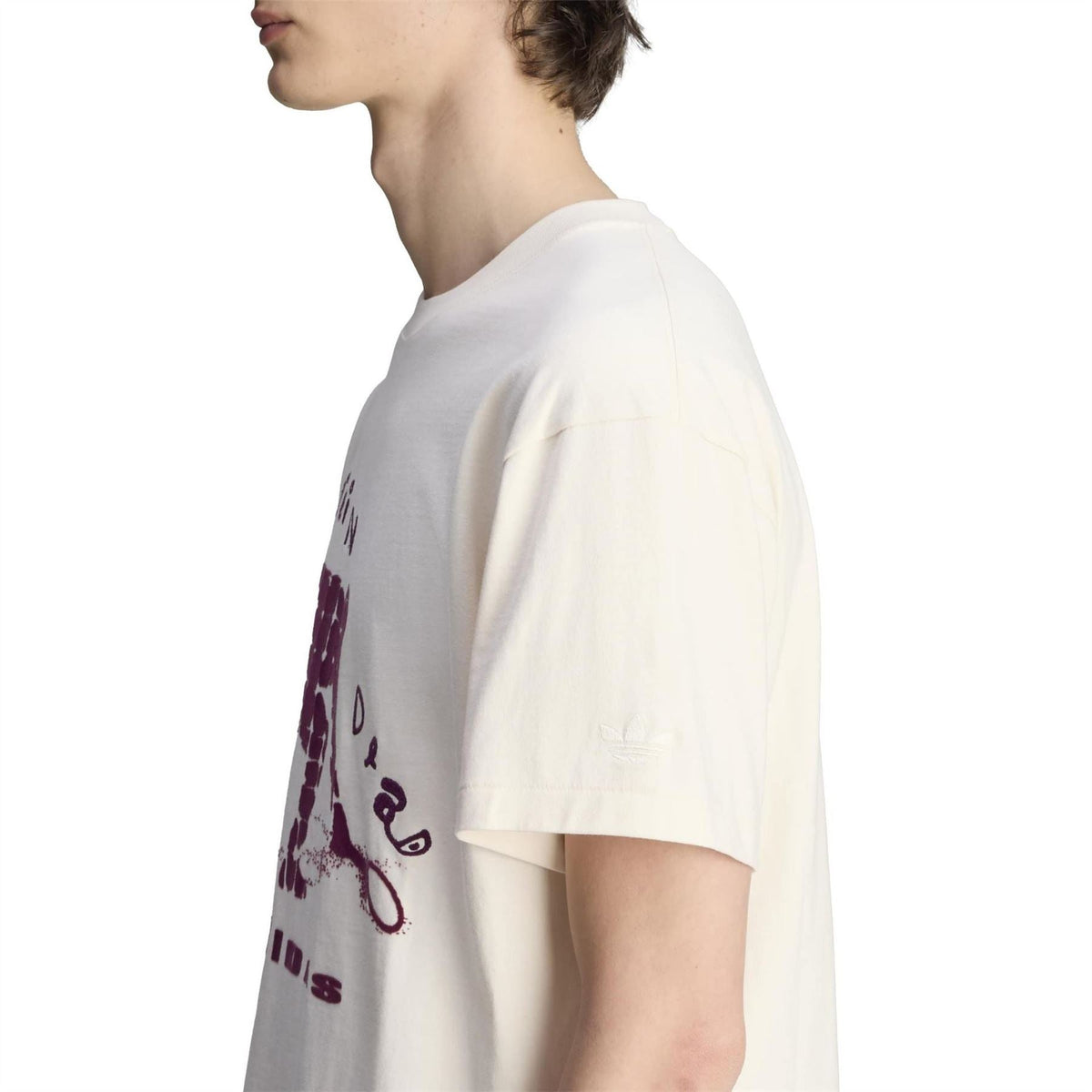 Wonder White T-shirt sleeve and side seam with partial maroon graphic