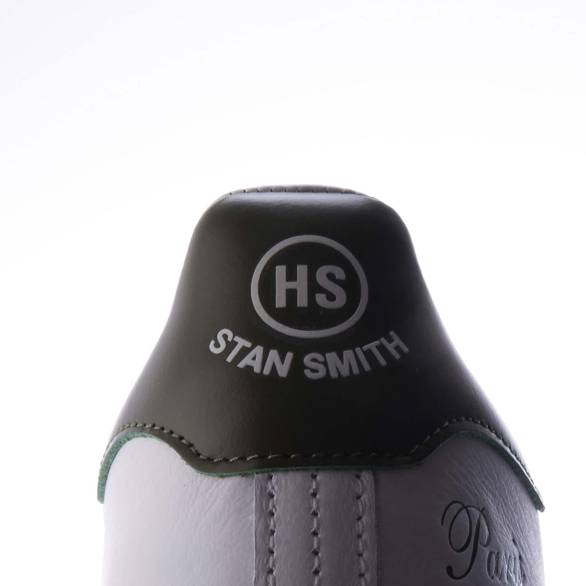 Black leather heel patch with 'HS Stan Smith' print on white sneaker