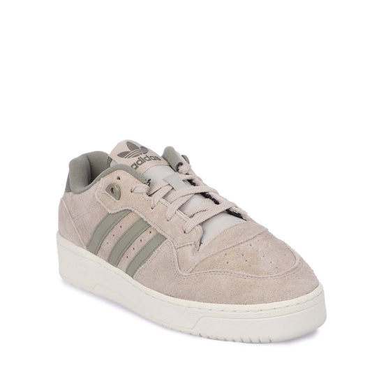 Beige suede lace-up trainers, side view with three metallic green stripes