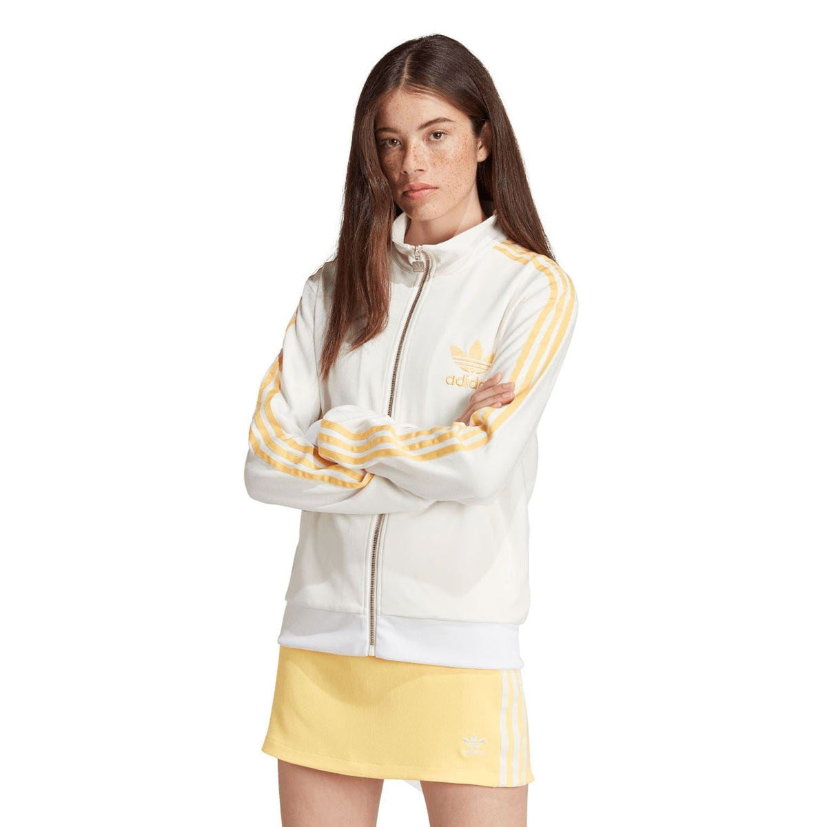 Off-white adidas track top with zip front, stand collar, and gold stripe sleeves