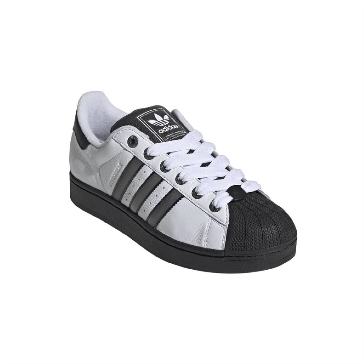 White leather low-top sneakers with black toe guard and Adidas logo on tongue