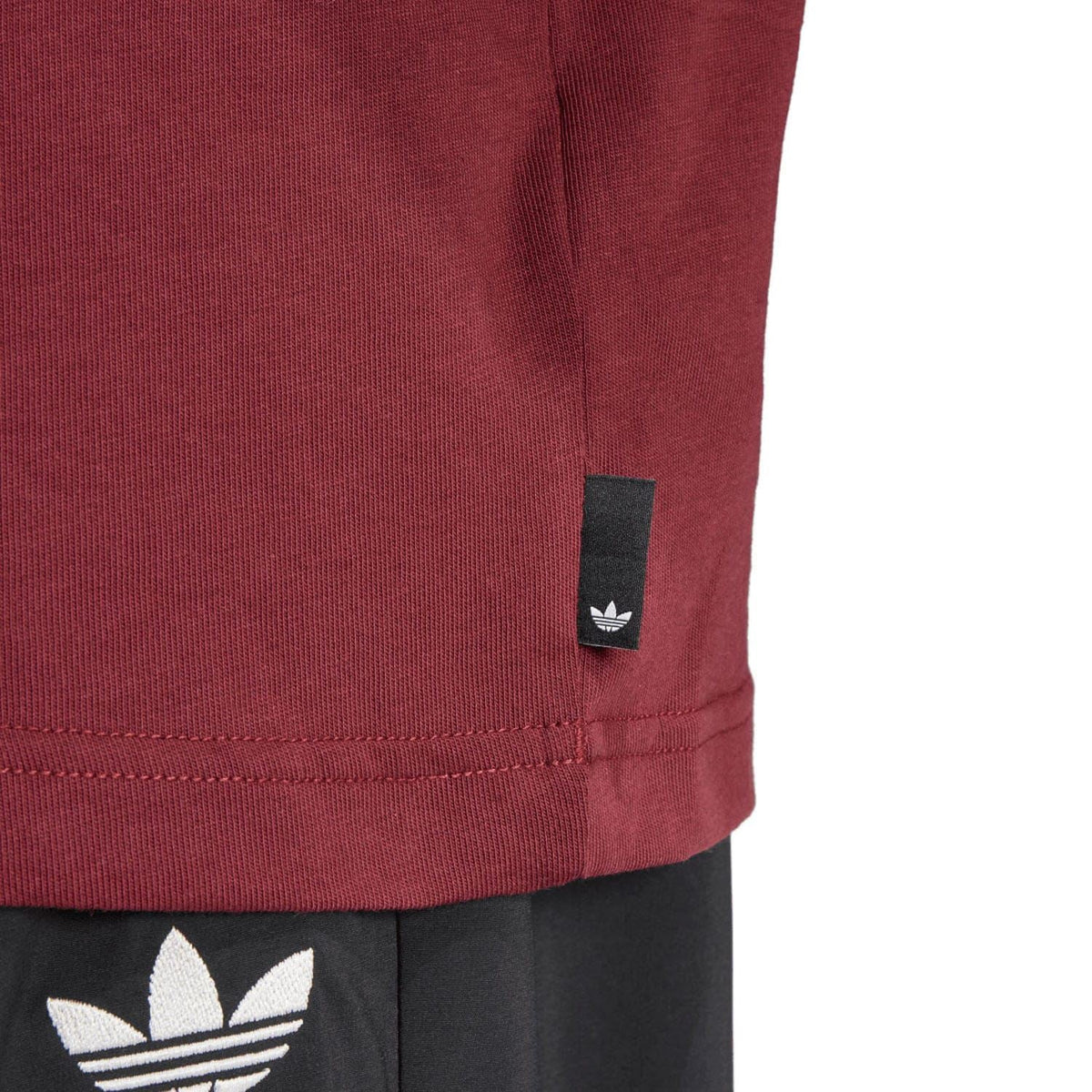 Maroon T-shirt with black adidas Originals sleeve hem tag detail