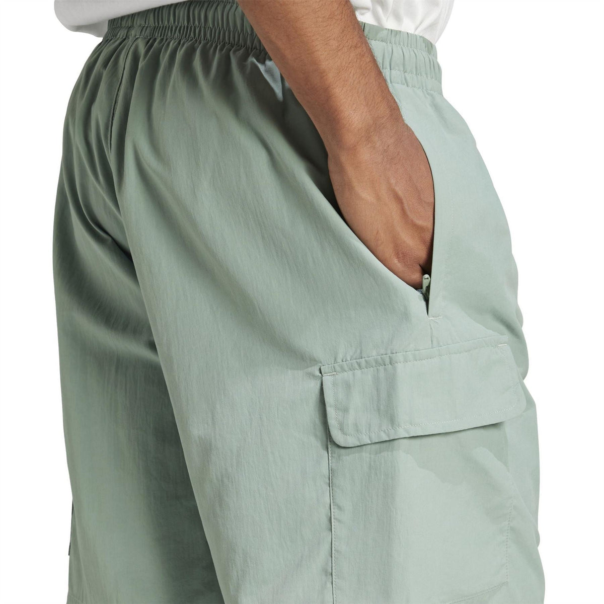 Mint green shorts detail: elastic waistband and side cargo pocket flap