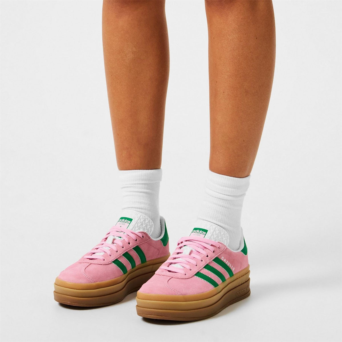 Pair of pink and green adidas Gazelle Bold trainers with gum platform sole