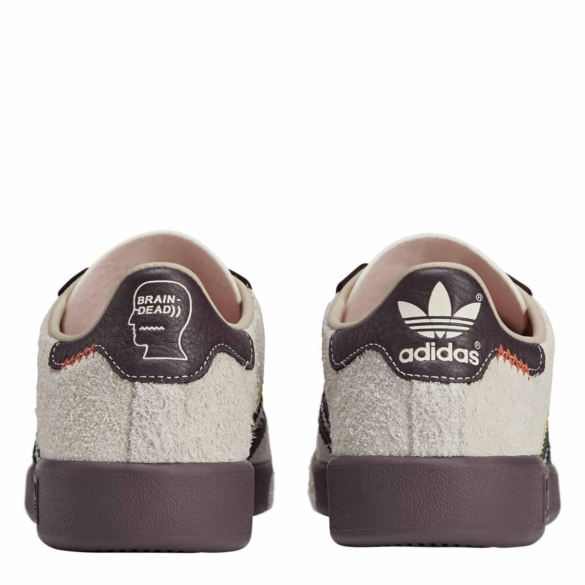 Low-top canvas sneakers with dark heel tab and tongue graphics on cream