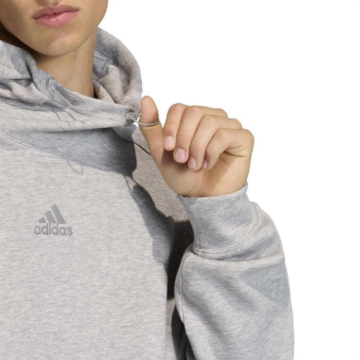 Grey hoodie close-up with adidas logo on chest and hood drawstring