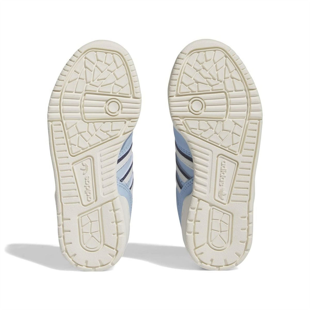 Light blue sneaker outsoles with textured tread pattern and adidas heel mark
