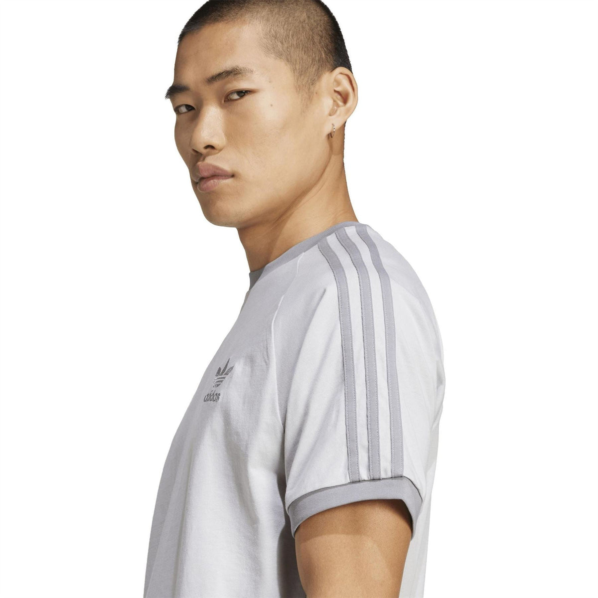 Light grey adidas T-shirt with three vertical sleeve stripes and small adidas logo