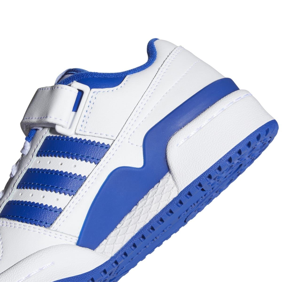 Close-up of kids white and blue low-top sneaker outsole and side stripes