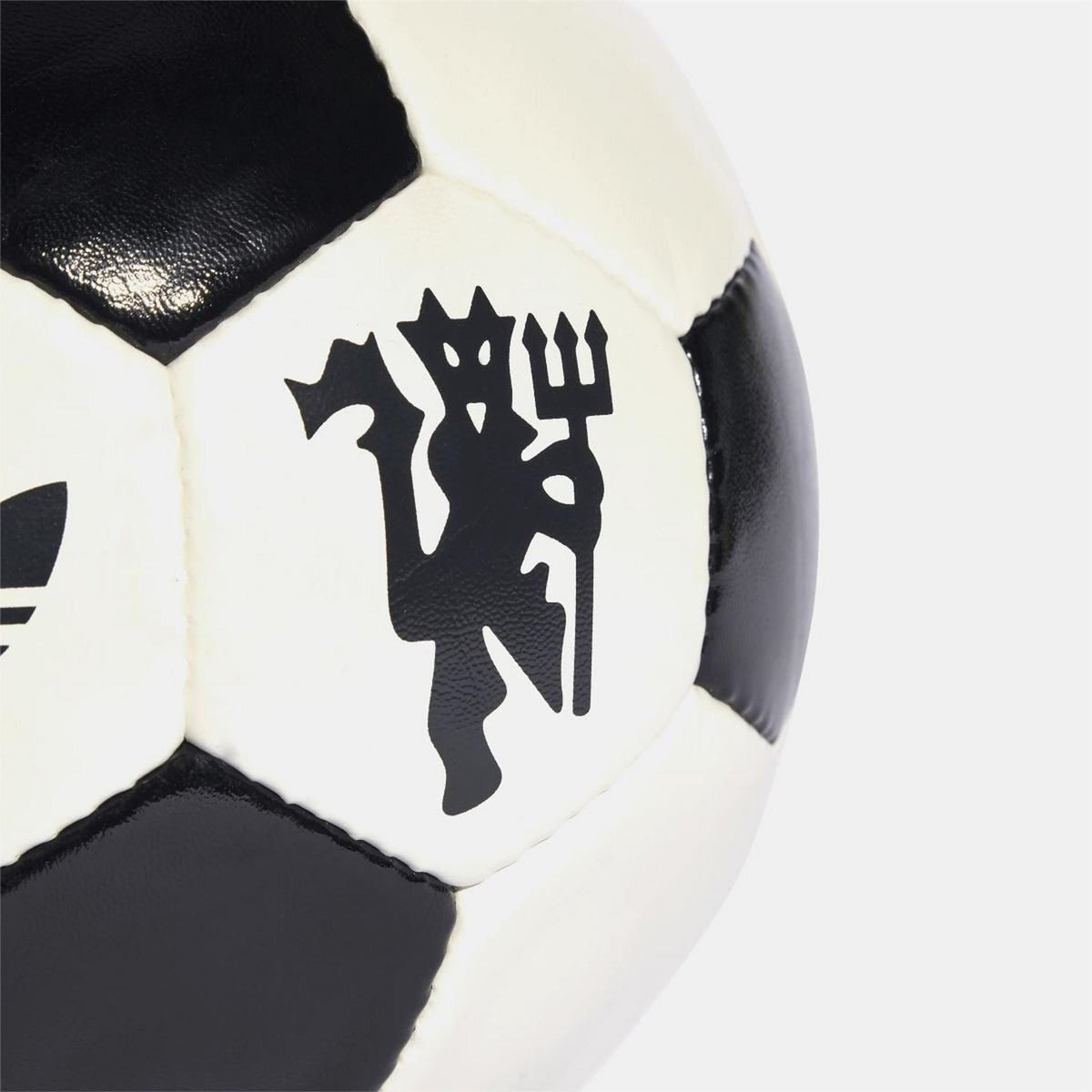 adidas Originals soccer ball close-up of black graphic emblem on off-white panel