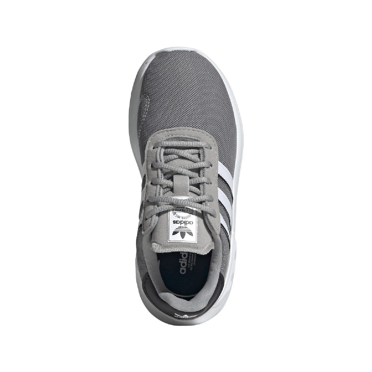 Grey kids trainer shoe viewed from front with lace-up closure and white stripes