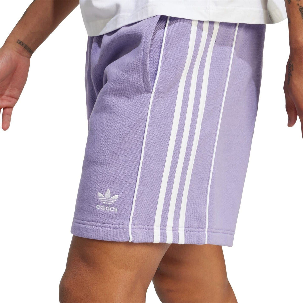 Lavender adidas athletic shorts with elastic waist and three white side stripes