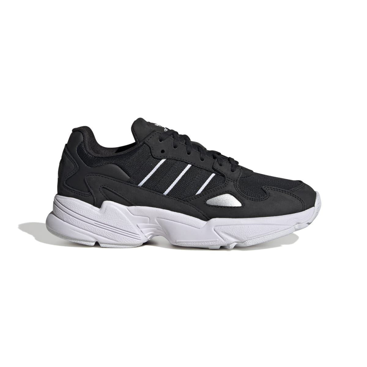 Black and white low-top sneakers with three stripes and chunky white midsole
