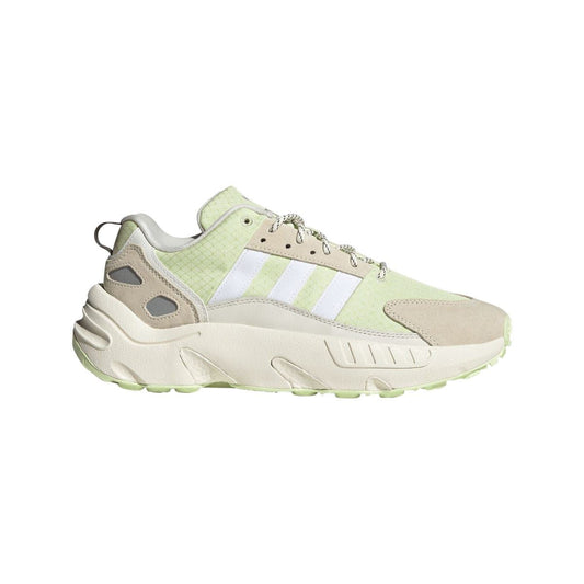 Off white low-top trainers with light green upper, suede overlays, and lace-up closure