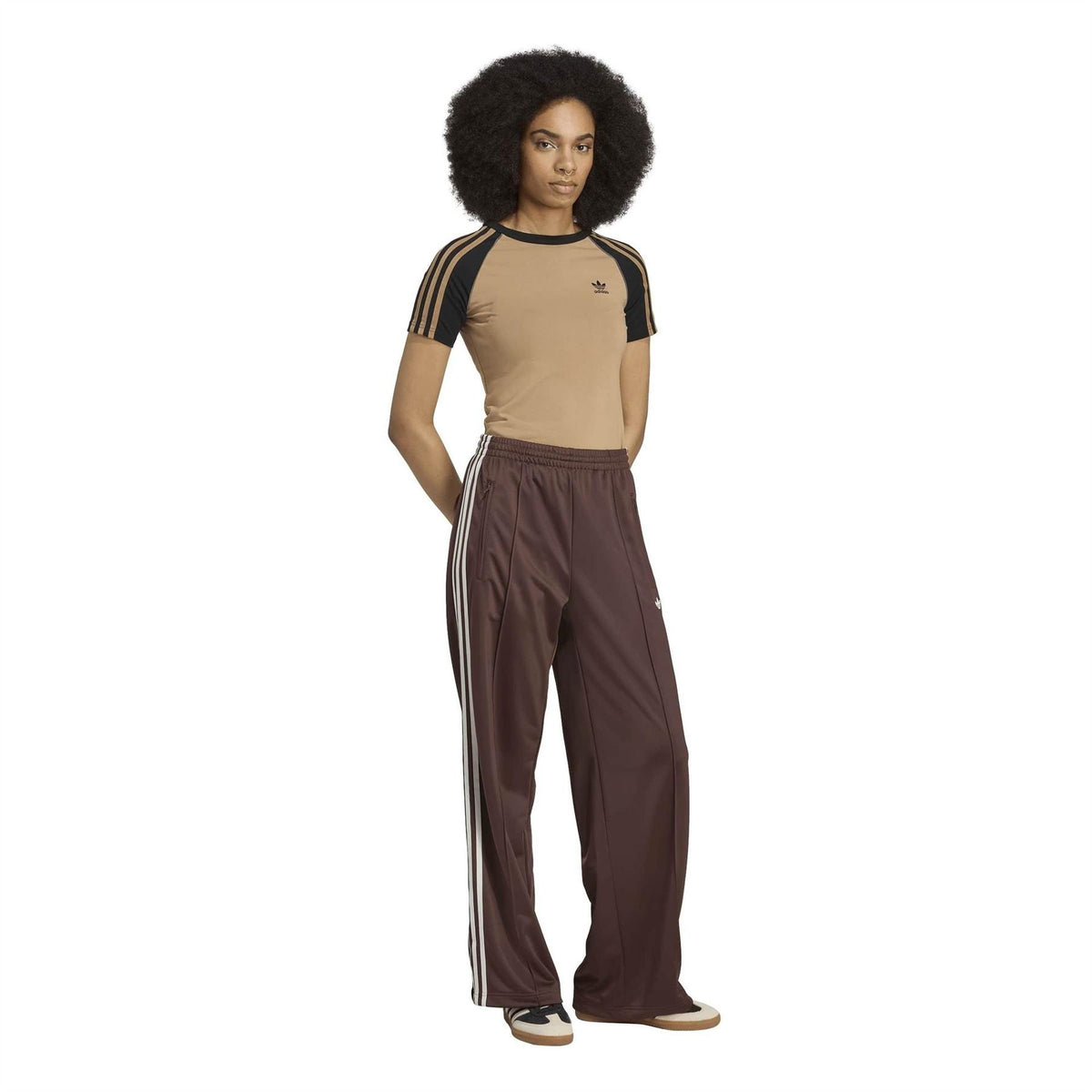 Brown adidas Originals track pants with full-length white side stripes and trefoil