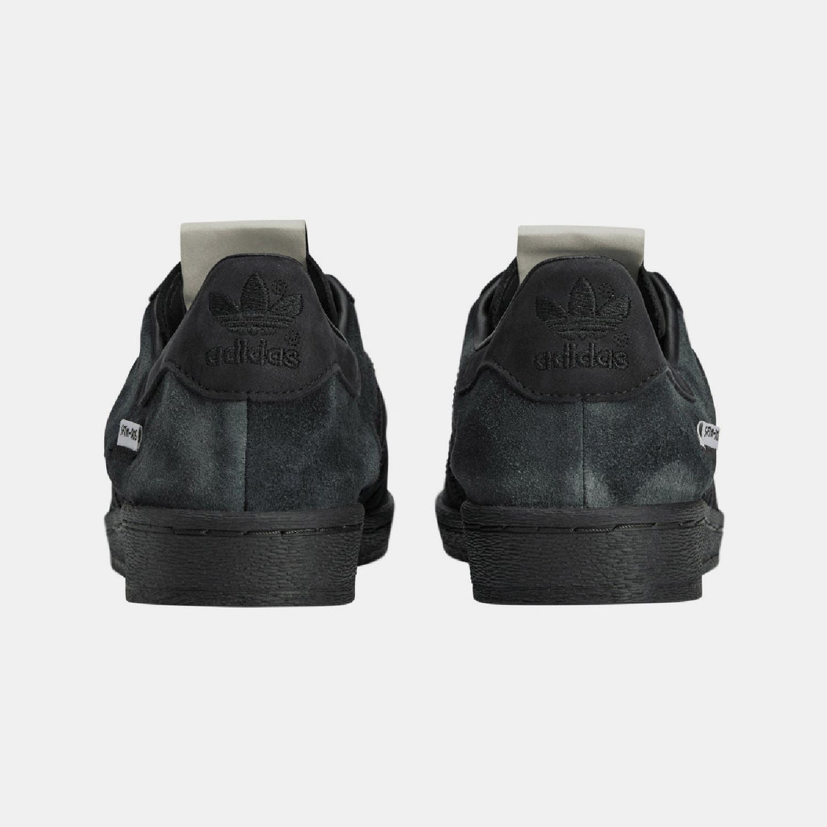adidas Originals SFTM Superstar 82 trainers featuring classic white leather with black accents and the iconic shell toe design