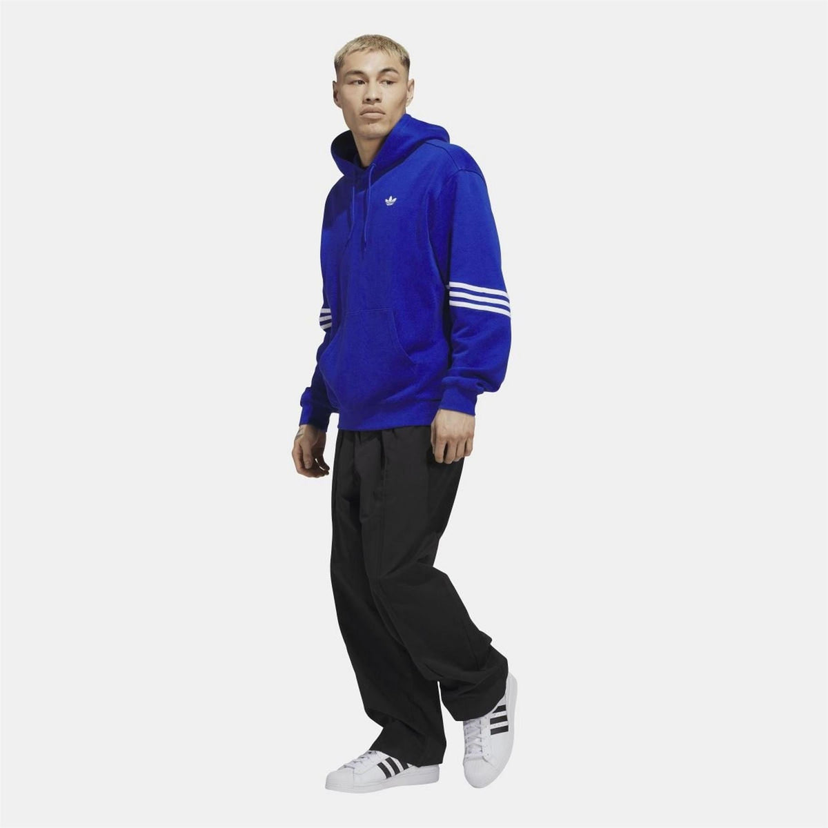 adidas Originals blue hoodie with drawstring hood, worn with black pants