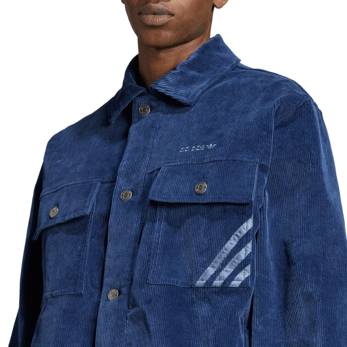 Indigo coach overshirt close-up with adidas logo and chest flap pocket