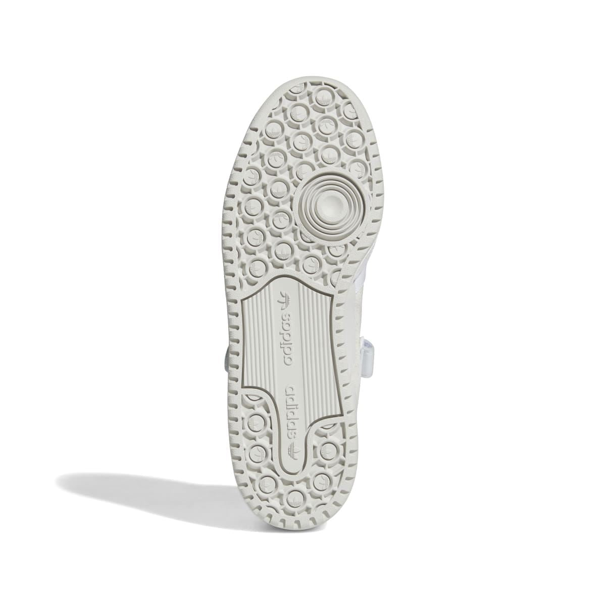 White trainer outsole with textured circular tread pattern and embossed branding