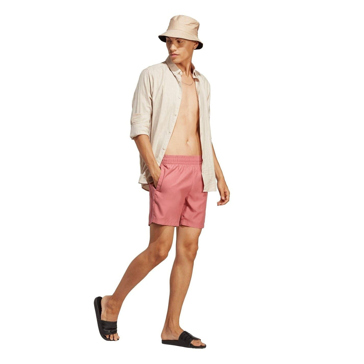 Pink swim shorts with adidas logo on the lower leg hem