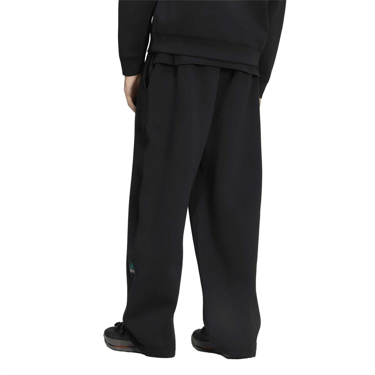Black EQT track pants with wide-leg shape and stitched seam details