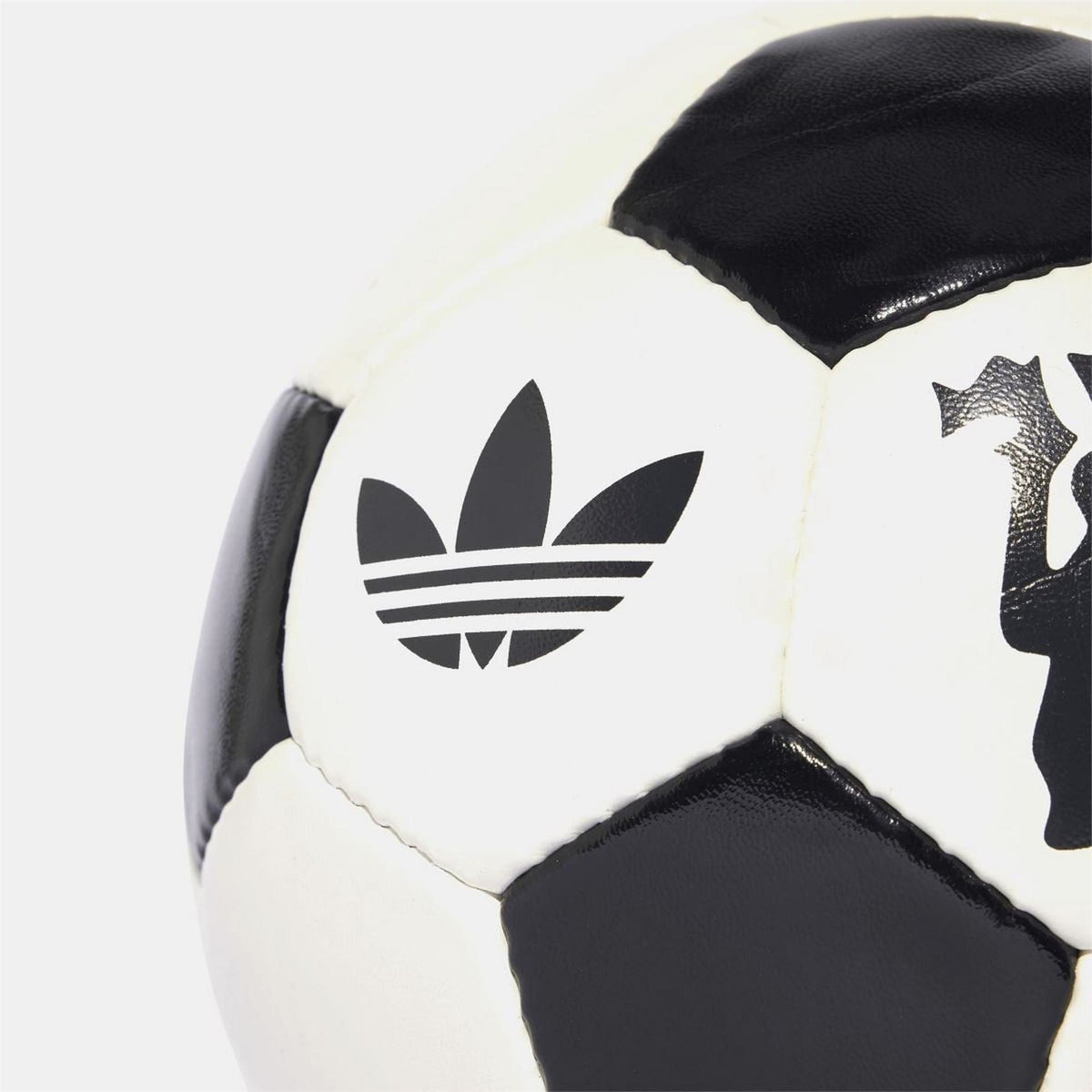 adidas Originals soccer ball close-up of adidas trefoil logo on off-white panel