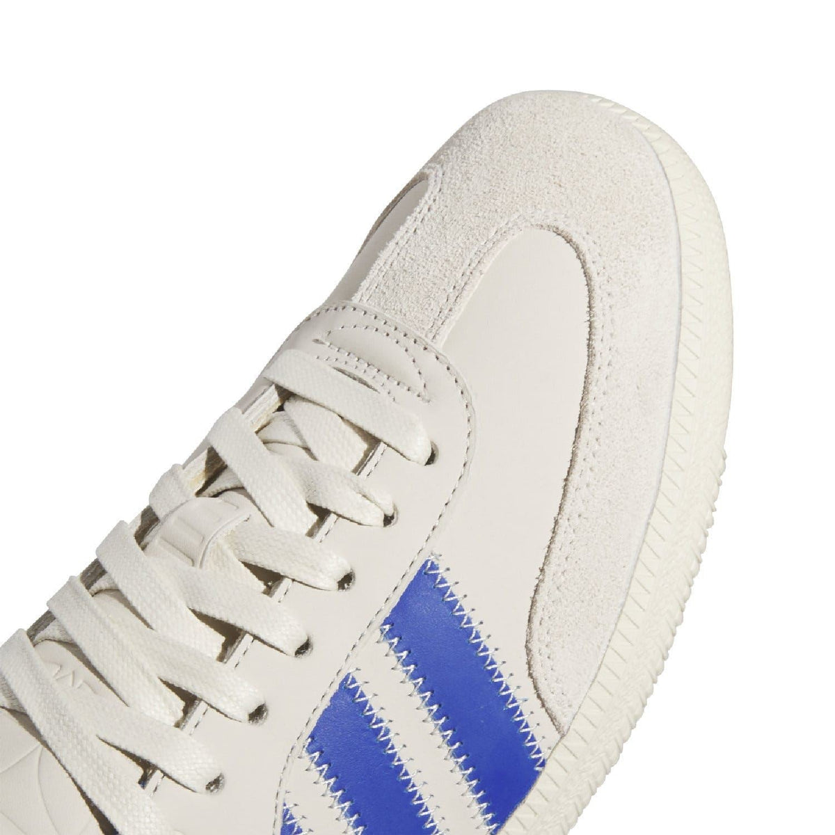 White suede upper with blue three-stripe panel and stitched lace-up closure
