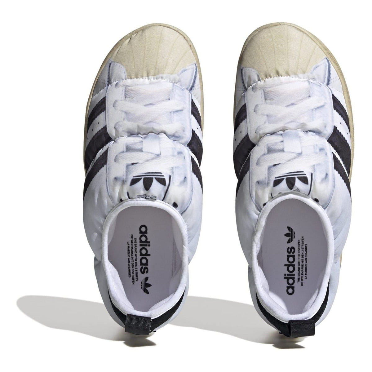 adidas Originals Puffy Spr trainers in white with three stripes, casual footwear with puffy design and supportive sole.