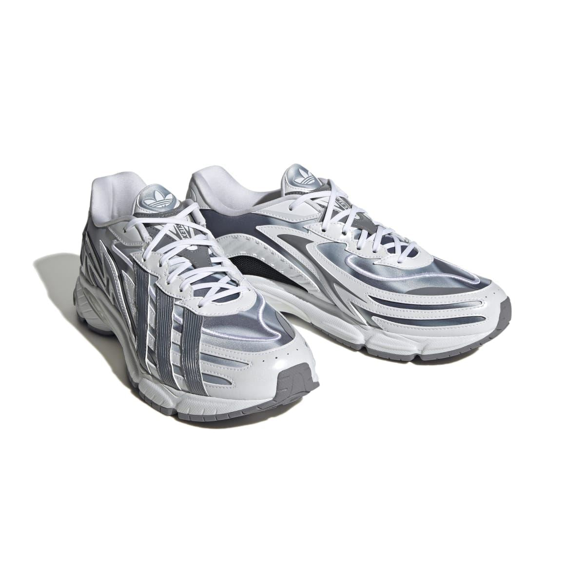 Pair of white and grey sneakers, angled view showing side stripes and lace-up uppers