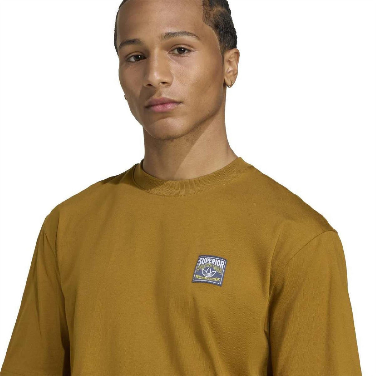 Close-up mustard-gold crew neck short sleeve T-shirt with small chest logo patch