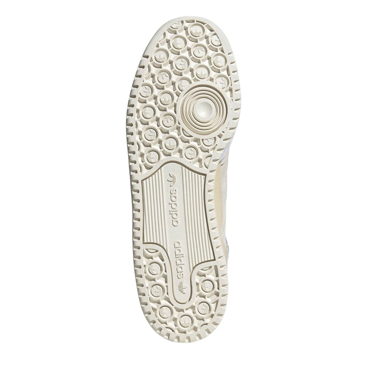 Sneaker outsole with textured circular tread and adidas logo, cream color