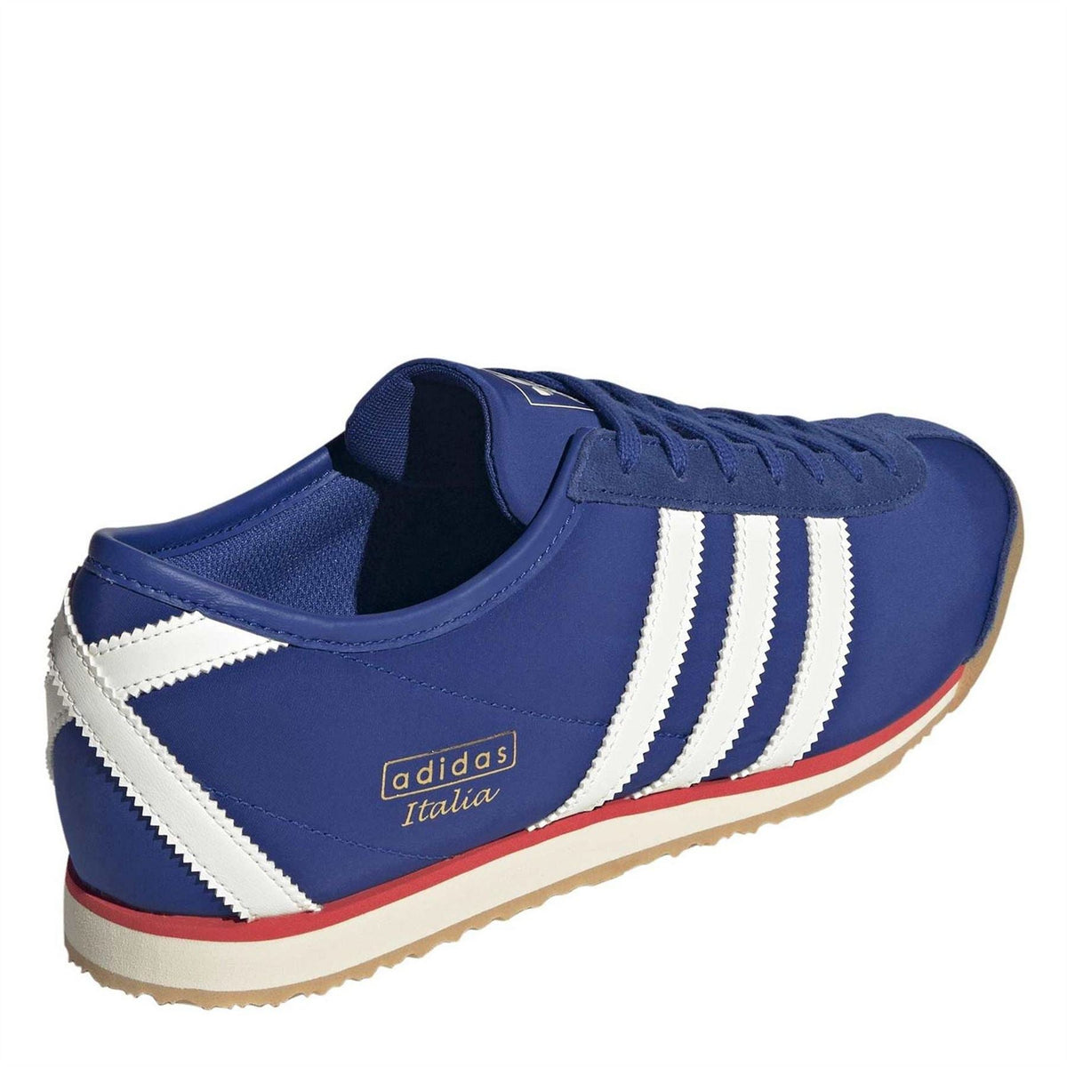 Royal blue low-top trainers with white side stripes and adidas Italia logo on heel
