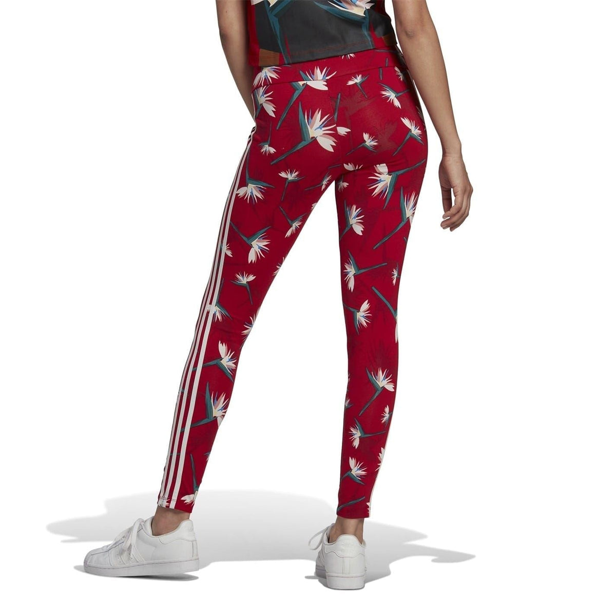 Red adidas leggings with tropical flower and leaf print and white side stripe detailing