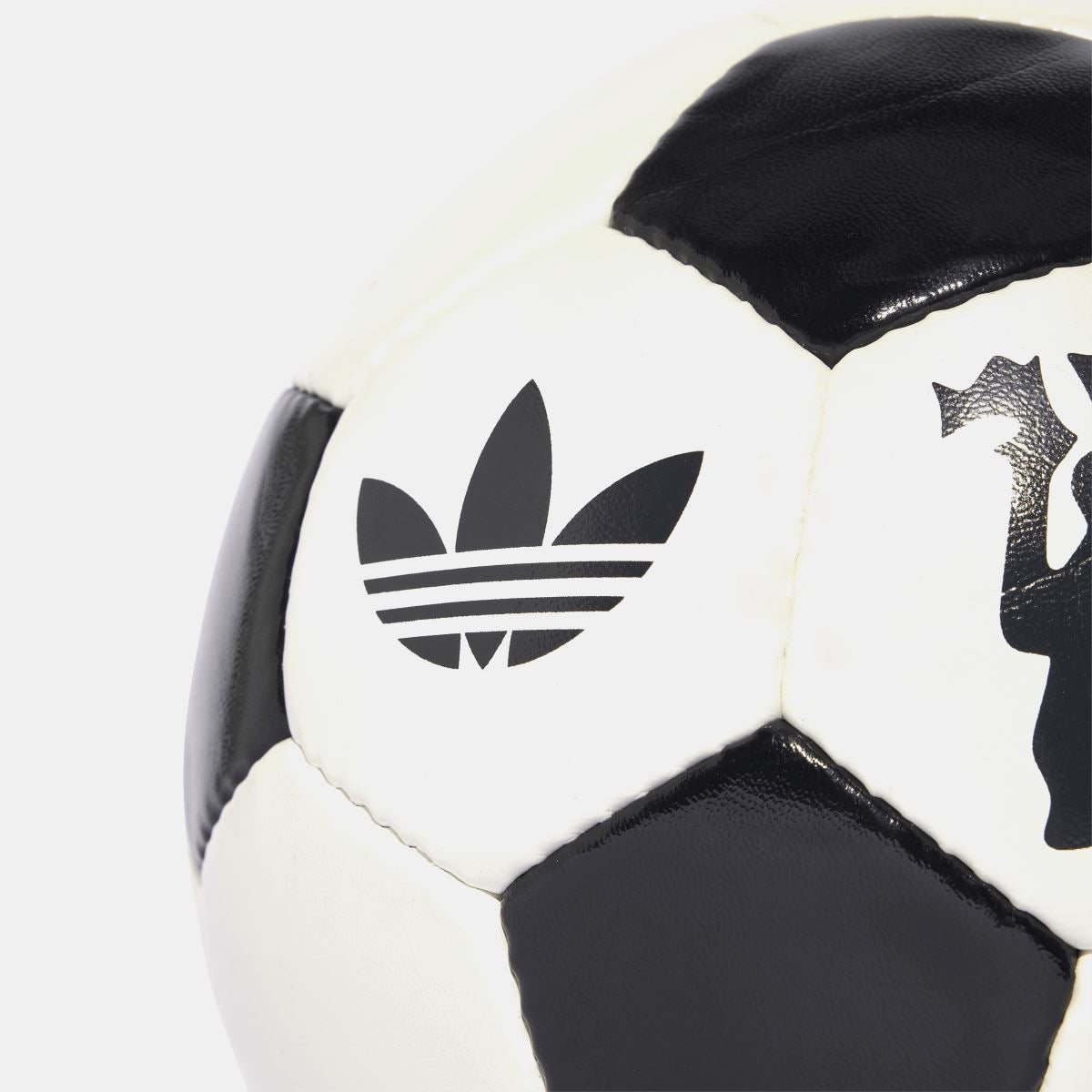 Off-white soccer ball side panel with adidas trefoil logo