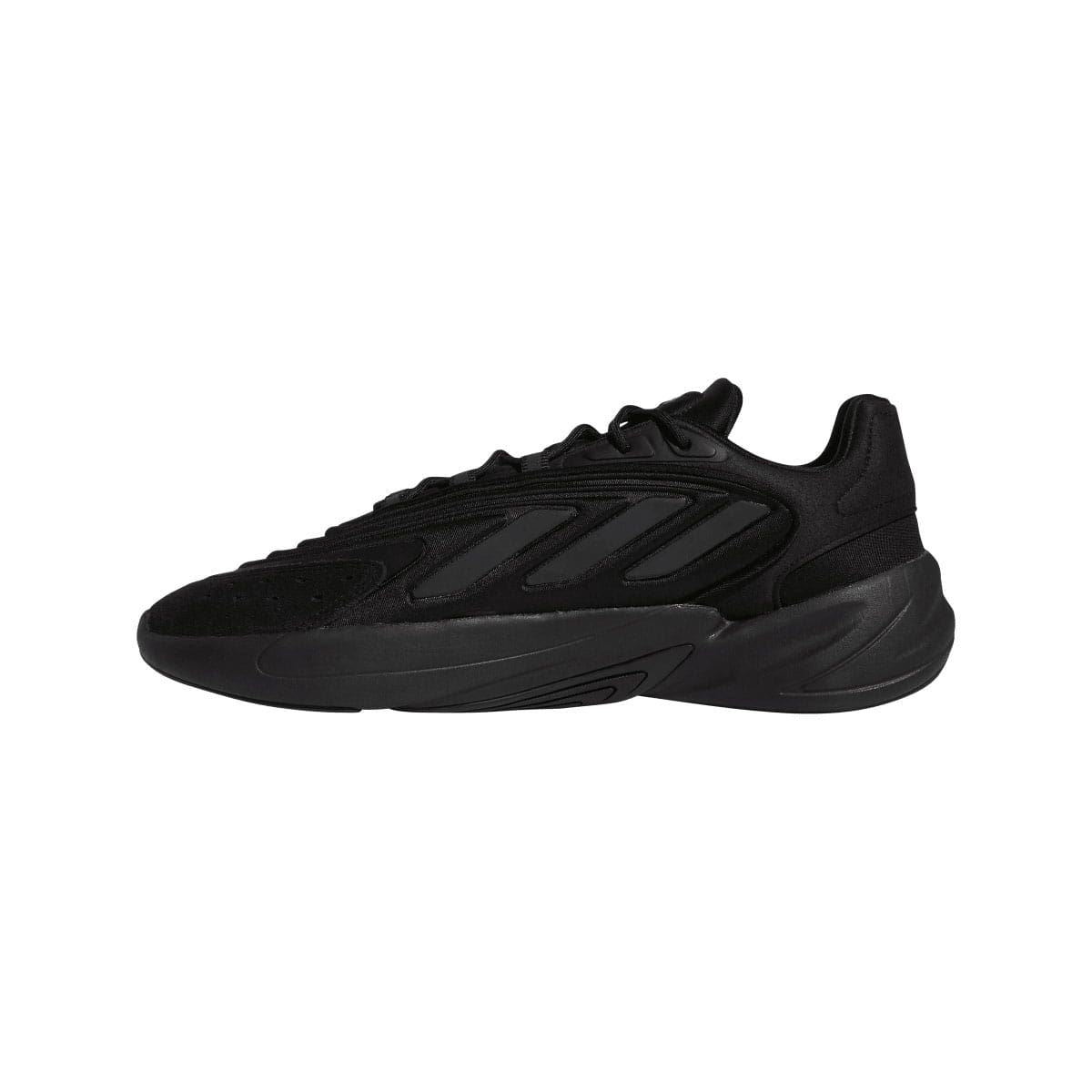 Black low-top trainers, side profile with textured overlays and lace-up