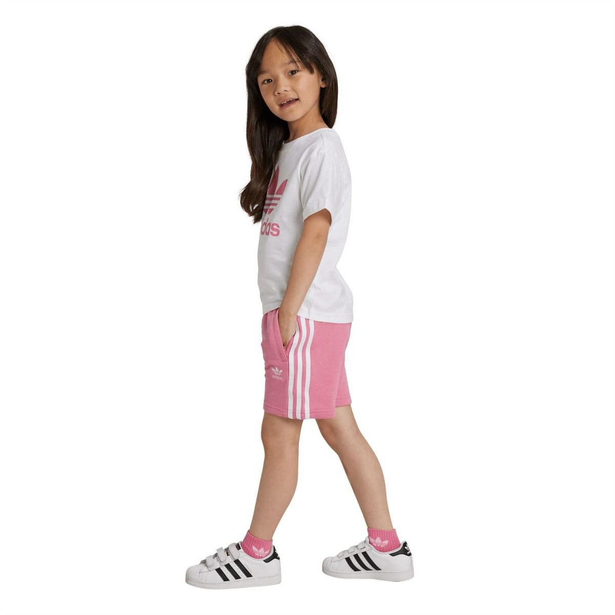 Side view: rose adidas shorts with trefoil emblem paired with white T-shirt