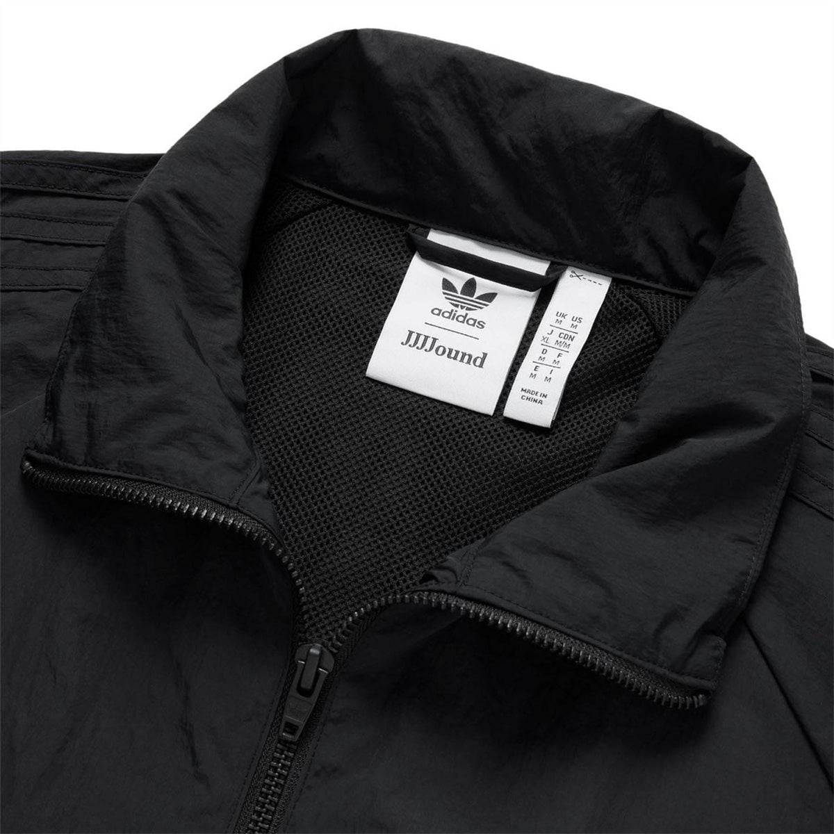 Black track jacket neckline and mesh-lined hood with Adidas label, front zipper