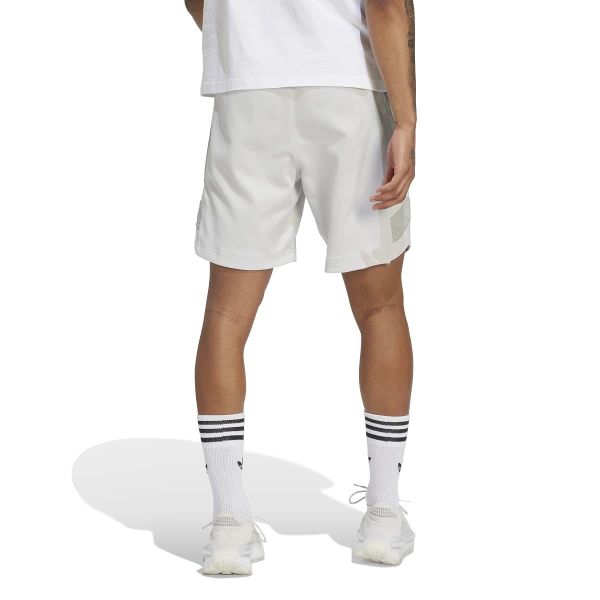 Light grey athletic shorts with elastic waistband and side pocket panel detail