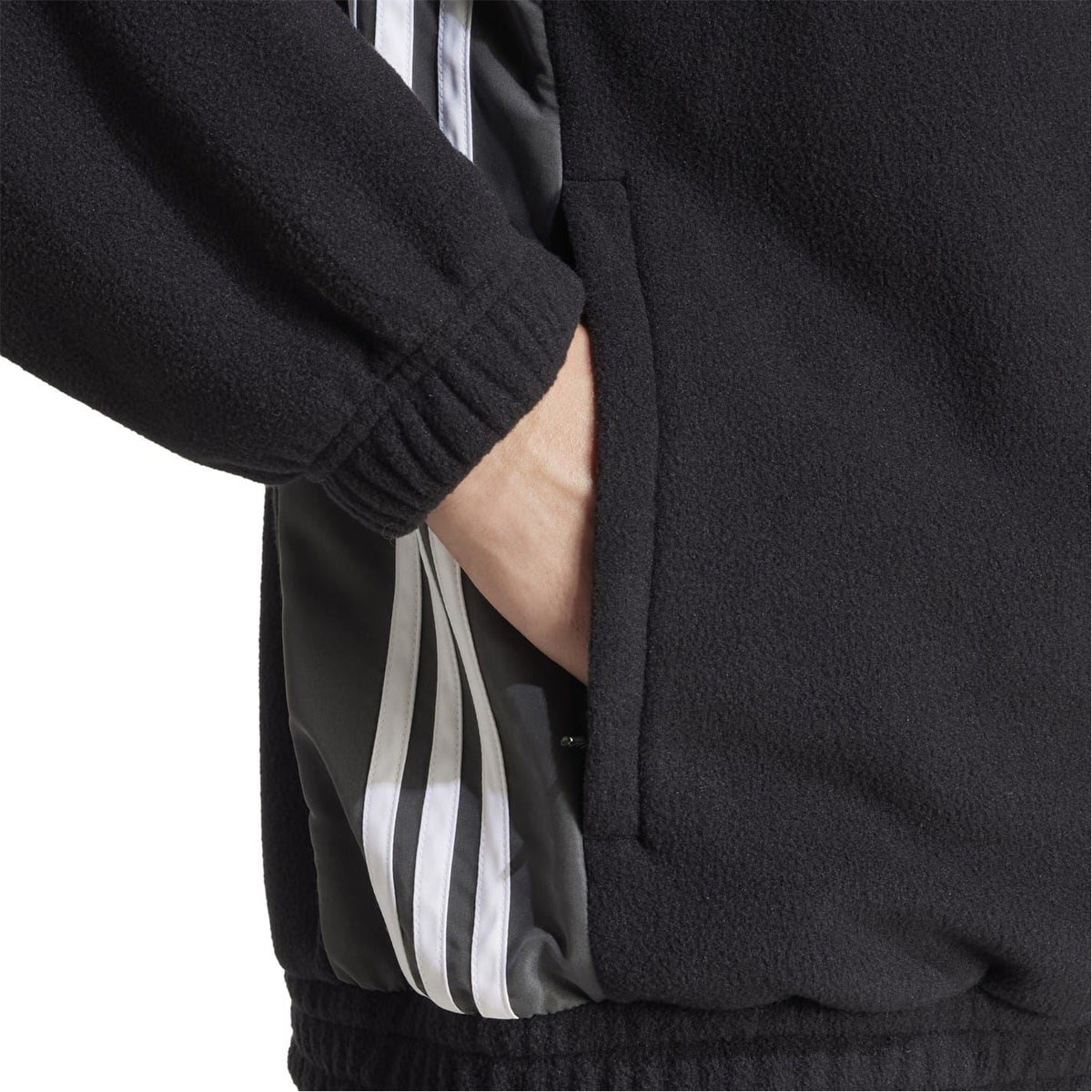Black zip sweatshirt detail with inner striped panel at pocket opening
