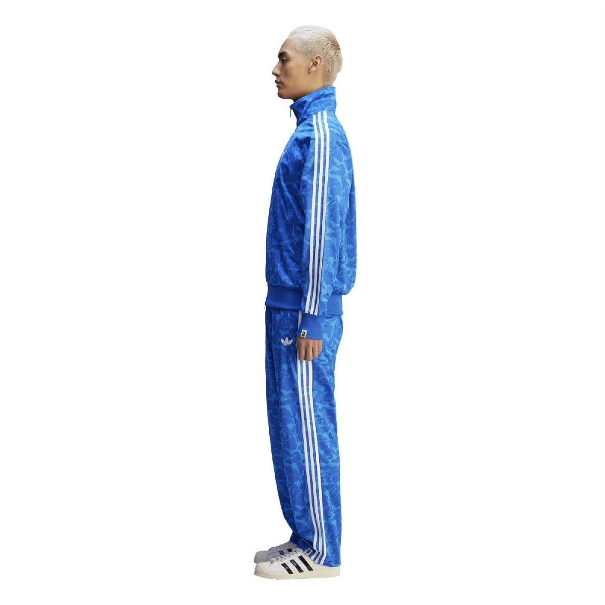 Blue patterned track top side view with white shoulder stripes and ribbed cuffs