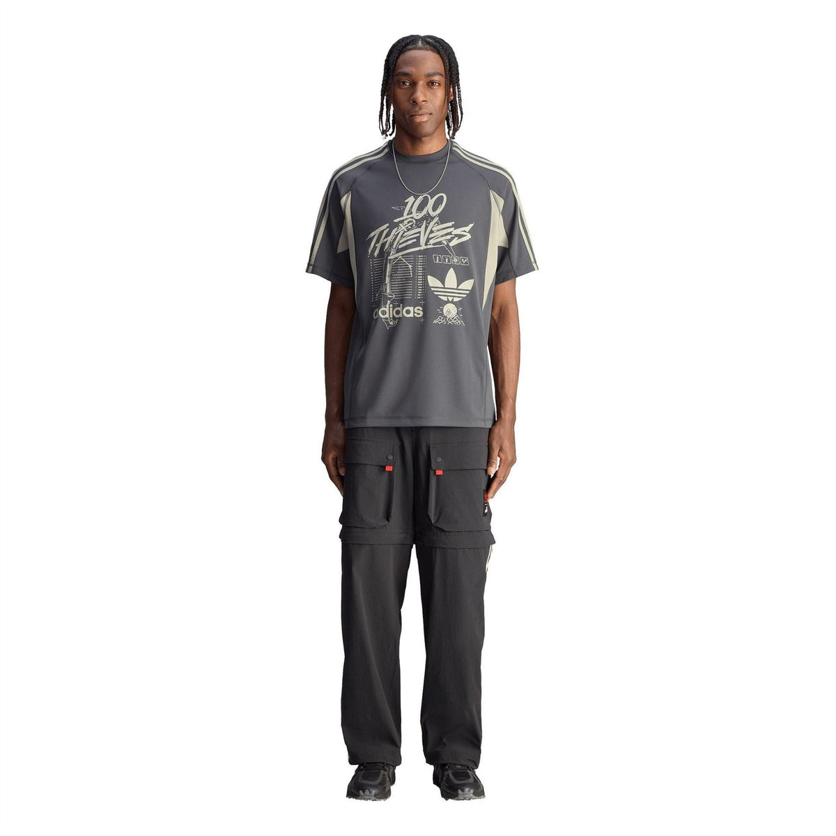 Adidas fleece jogger pants in black with cargo pockets and white side stripes