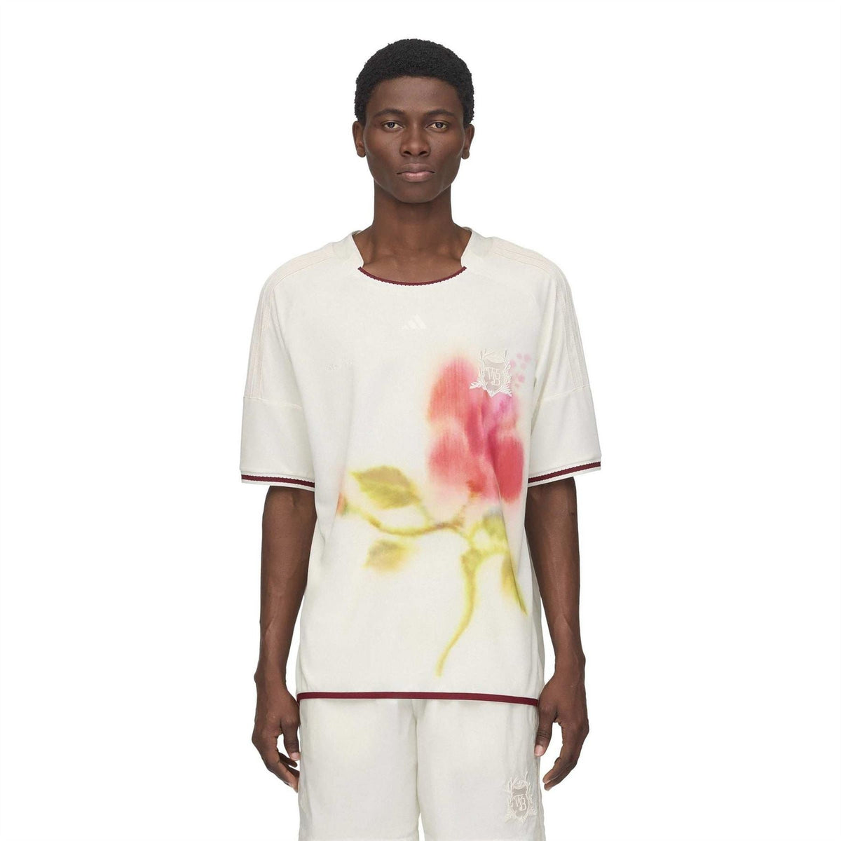 White football jersey with floral watercolor print and burgundy-trimmed crew neck and sleeves