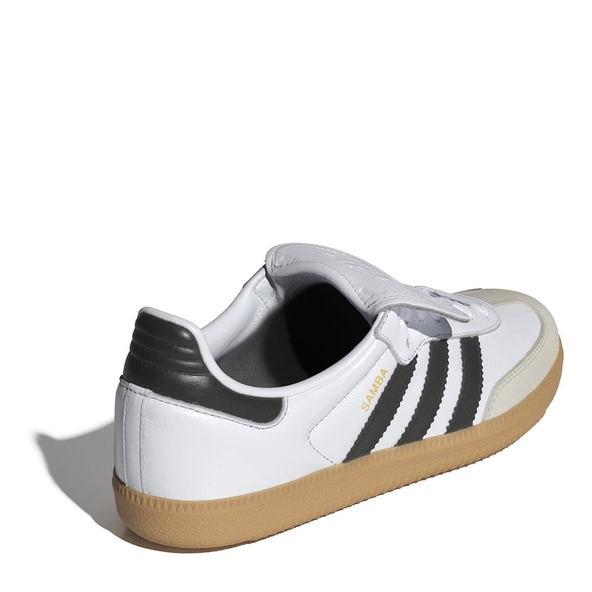 White low-top sneakers with black stripe accents, gum rubber sole, and lace-up closure.