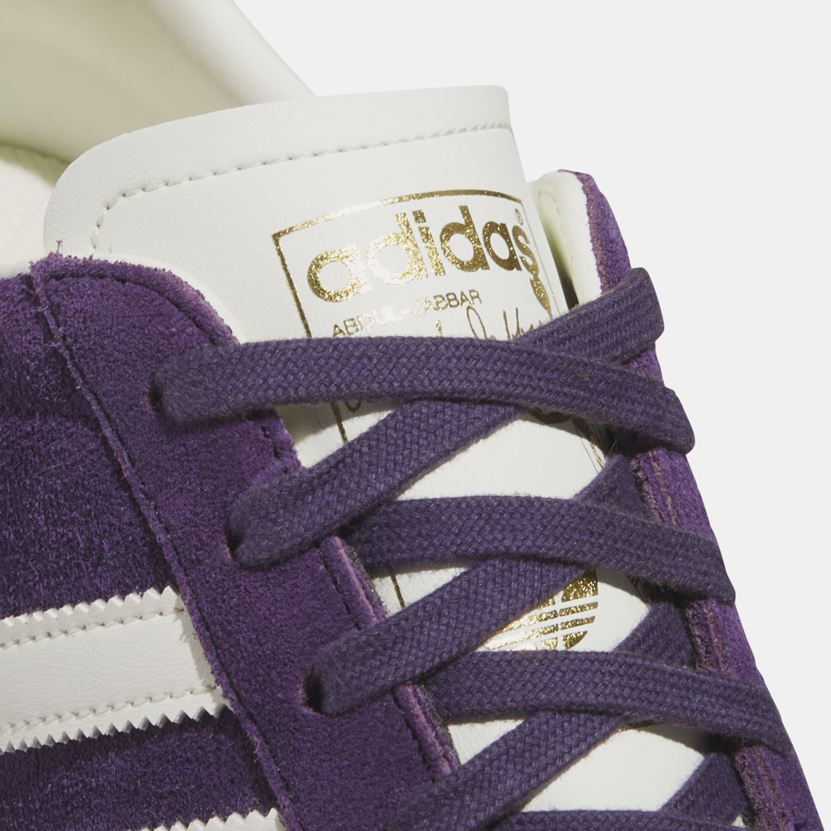 Close-up of purple adidas Originals Jabbar Lo laces and tongue label under the eyelets