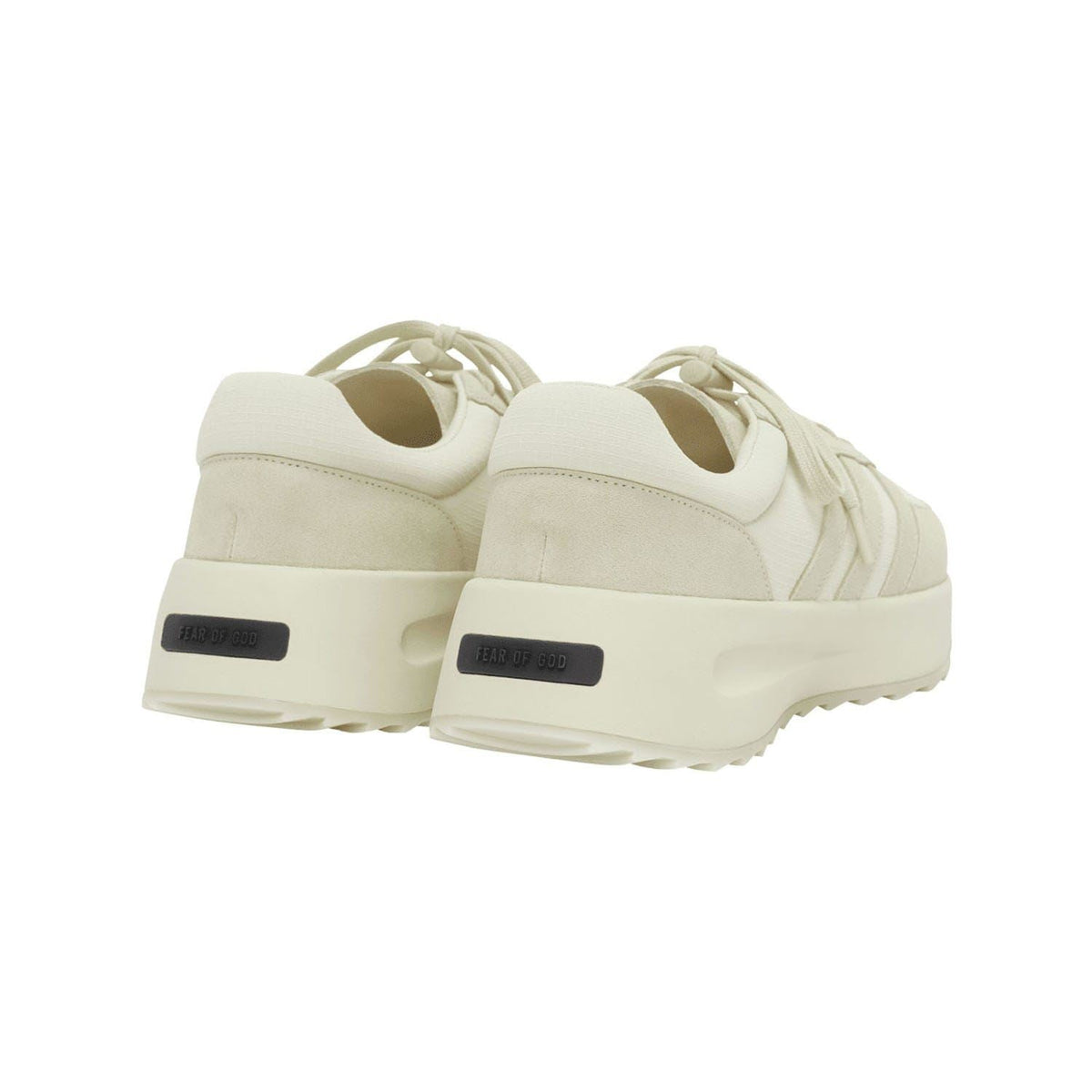 Cream low-top trainers rear view with cushioned collar and heel branding