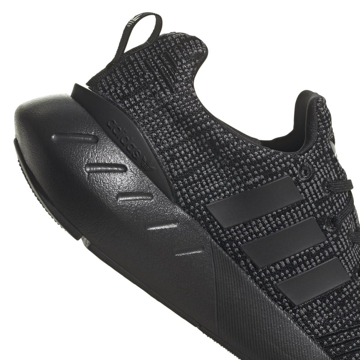 Kids' adidas trainers side profile with dark knit upper and black molded heel cap