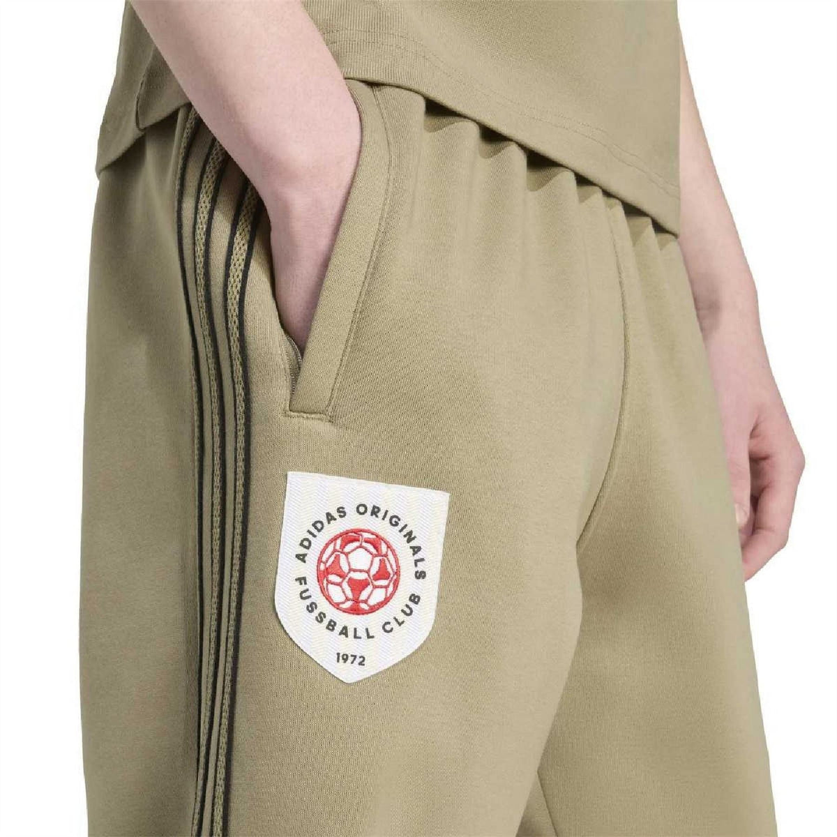 Olive-green joggers with side logo patch and vertical stripe detail