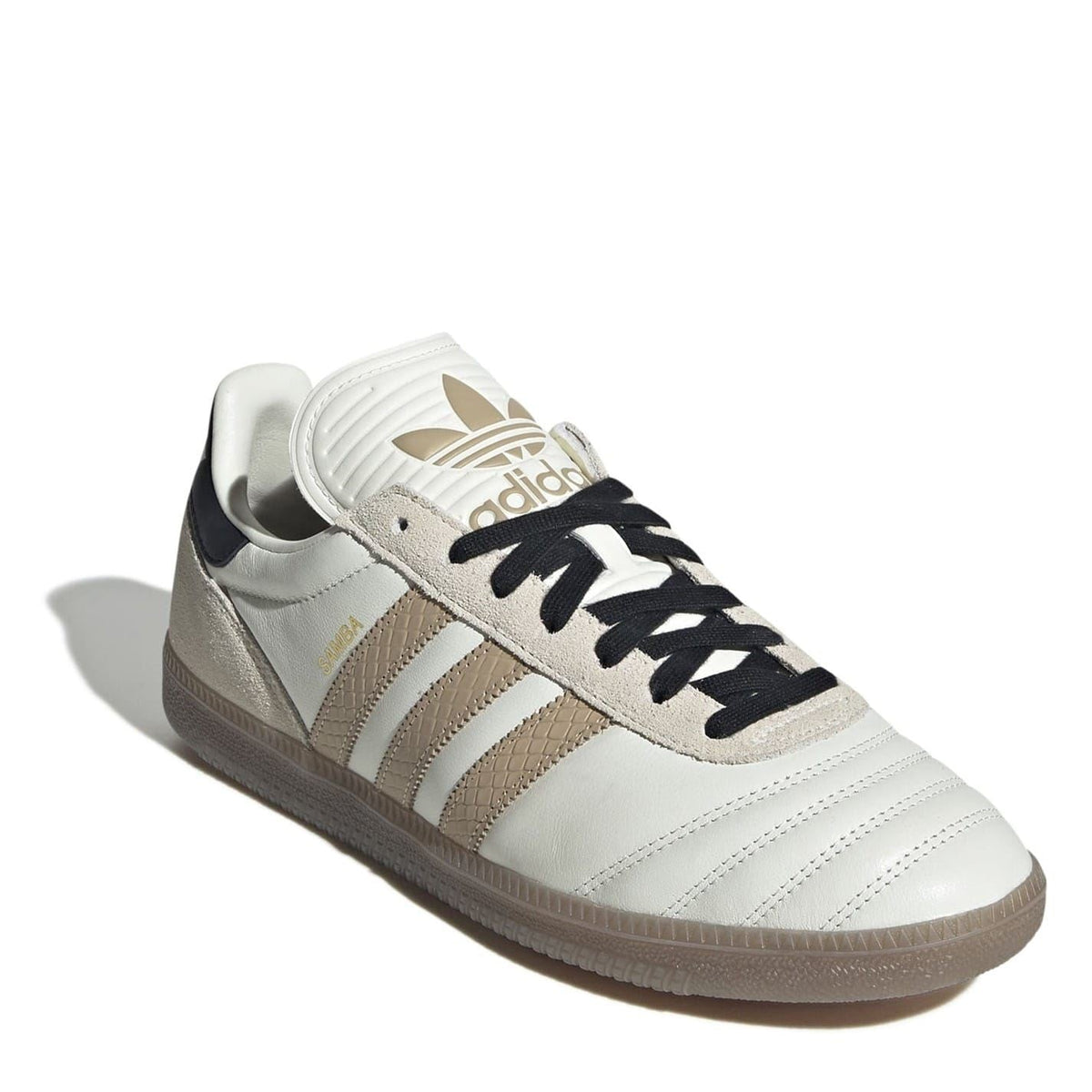 White leather sneakers with beige suede accents, black laces, and adidas-style logo on tongue