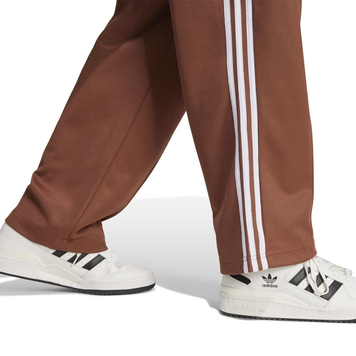 Brown track pants with white triple side stripes and elastic hem